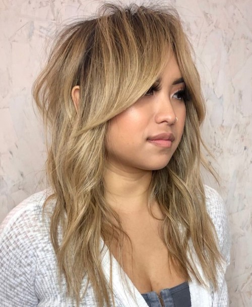 Shaggy Wolf Cut with Swooping Bangs Messy Blonde Shag with Long Curtain Bangs