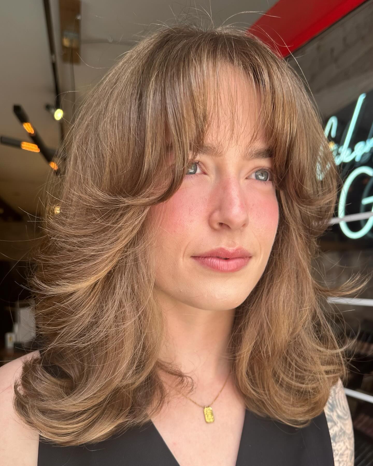 Medium Haircut with Thin Bangs and Flipped Ends
