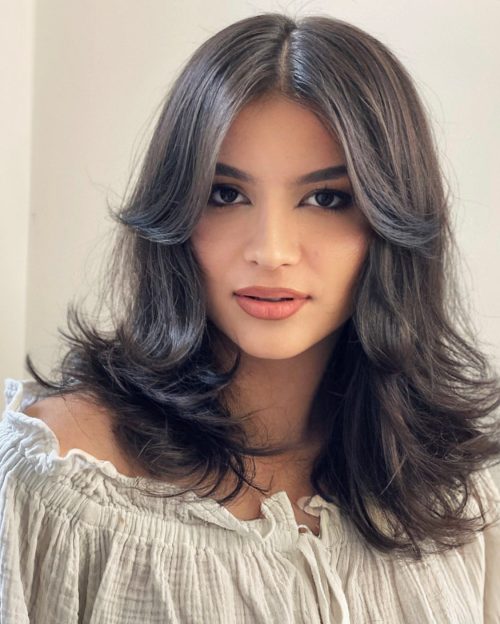 Mid Length Feathered Hairstyle with Curtain Bangs